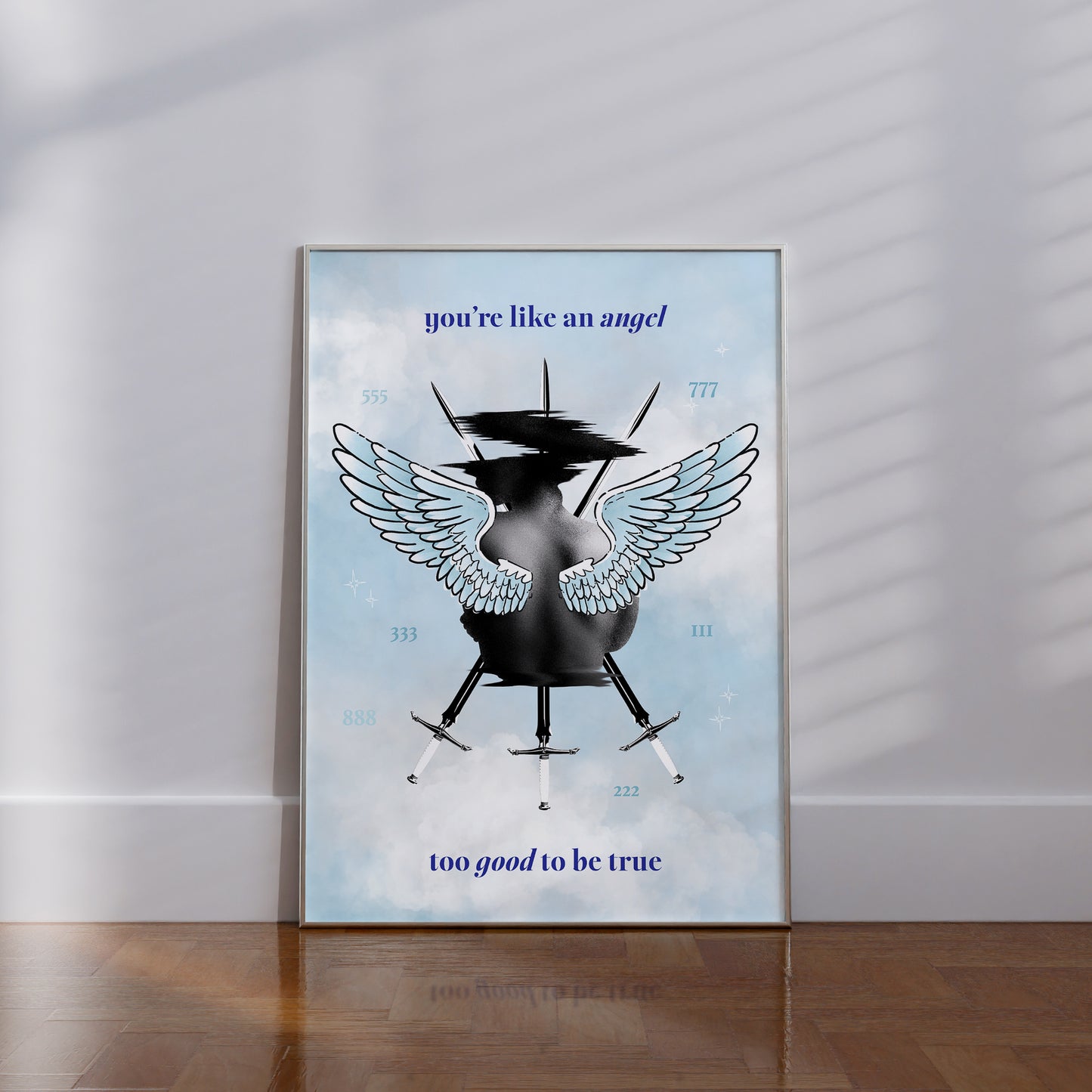Framed Angel Baby art print sitting on the floor featuring Three of Swords tarot, angel wings, and pastel cloud background.