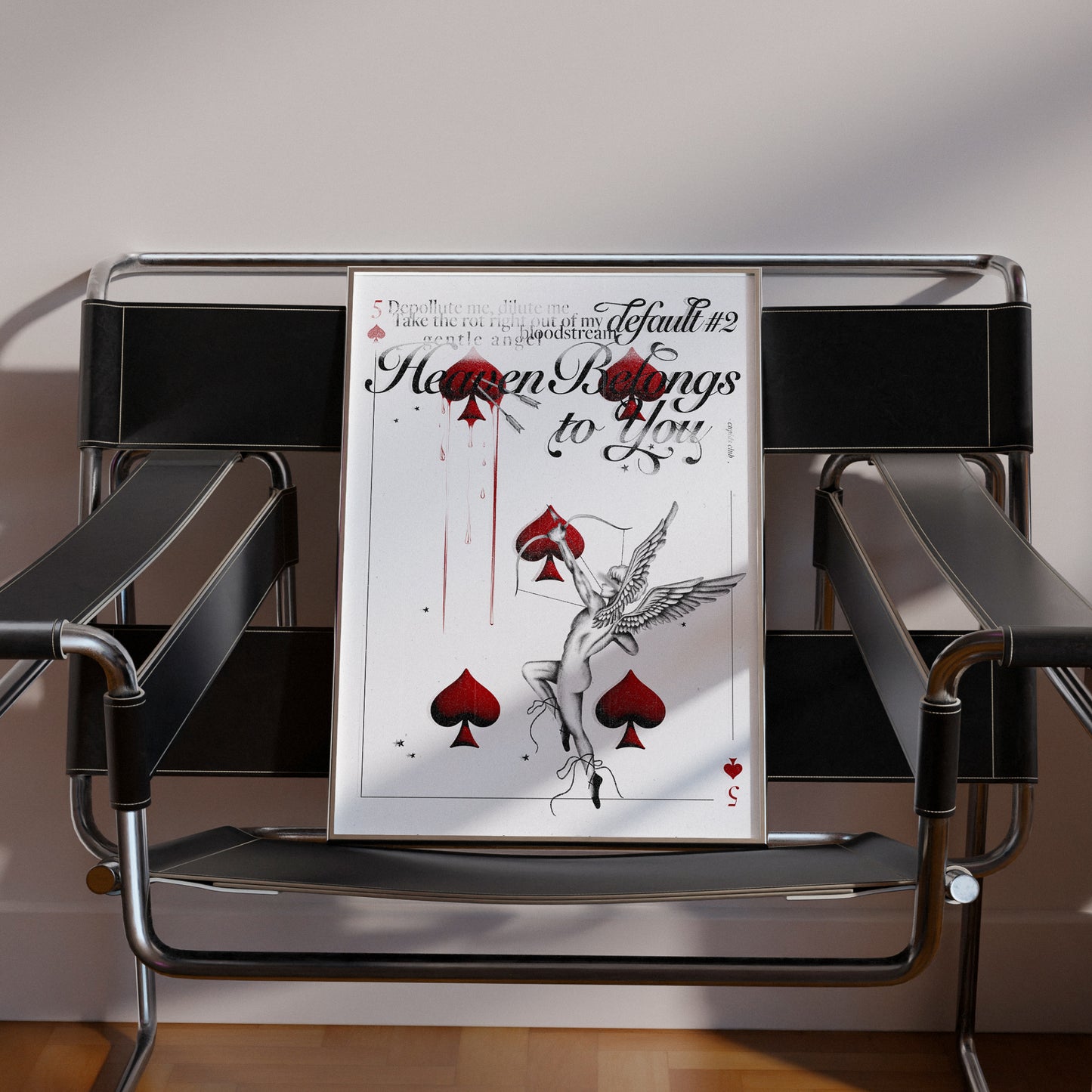 Heaven Belongs to You print sitting on black modern chair.