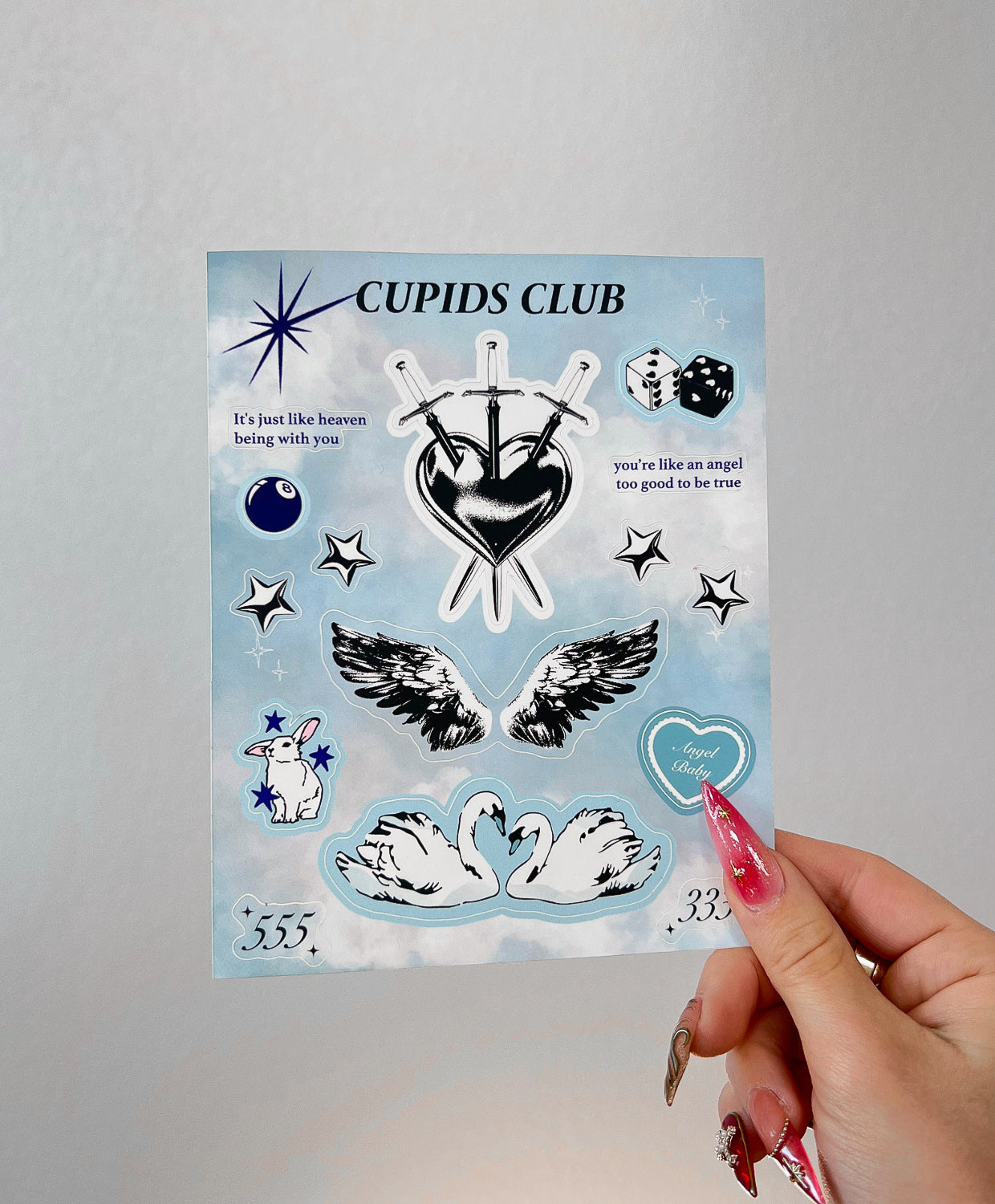 Angel Baby sticker sheet next to a hand for size comparison