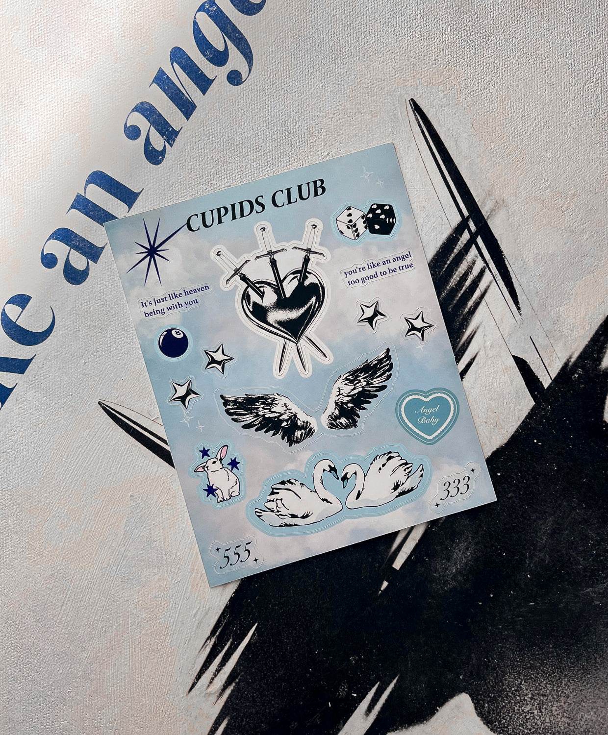 Angel Baby stickers laying on Angel Bay print collection.