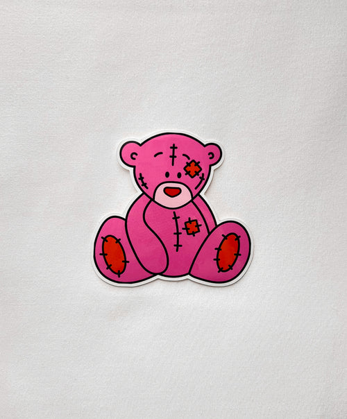 Cutie Bear Vinyl Sticker featuring a sad pink teddy bear with patches