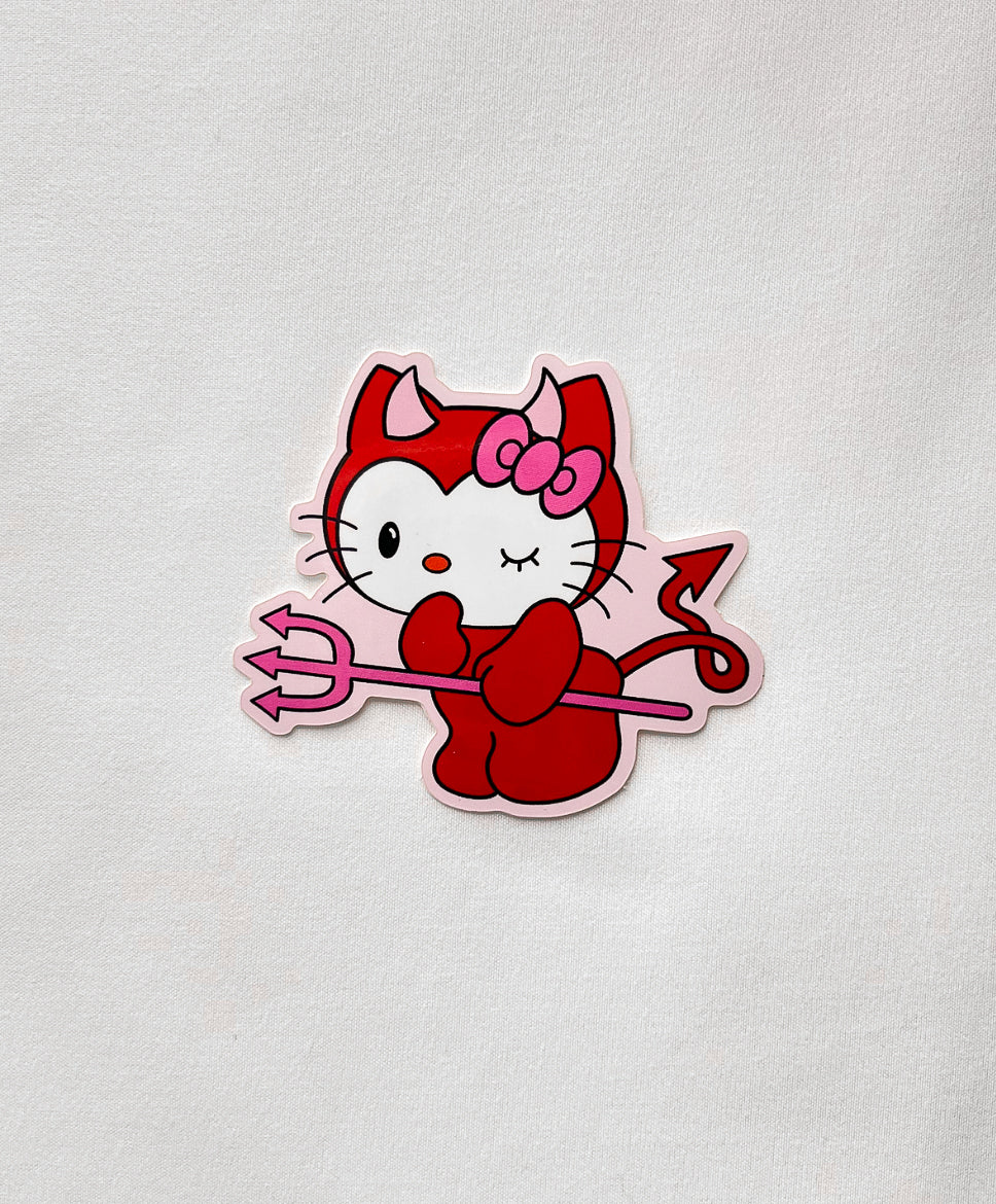 Devil Kitty Sticker featuring a cute white kitty dressed as a red devil, holding a pink pitchfork