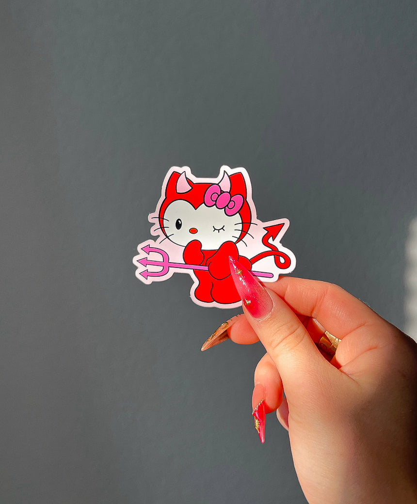 Devil Kitty Sticker in sunlight next to a hand for size comparison