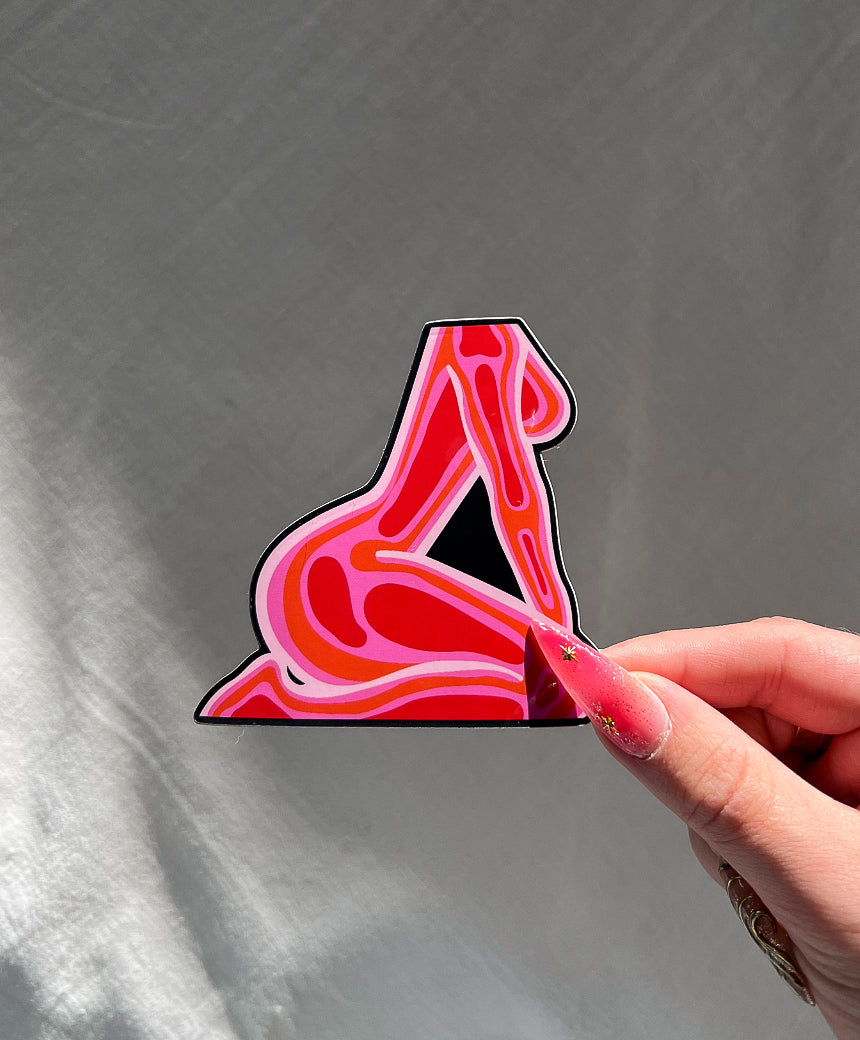 Feminine Energy Sticker next to a hand for size comparison