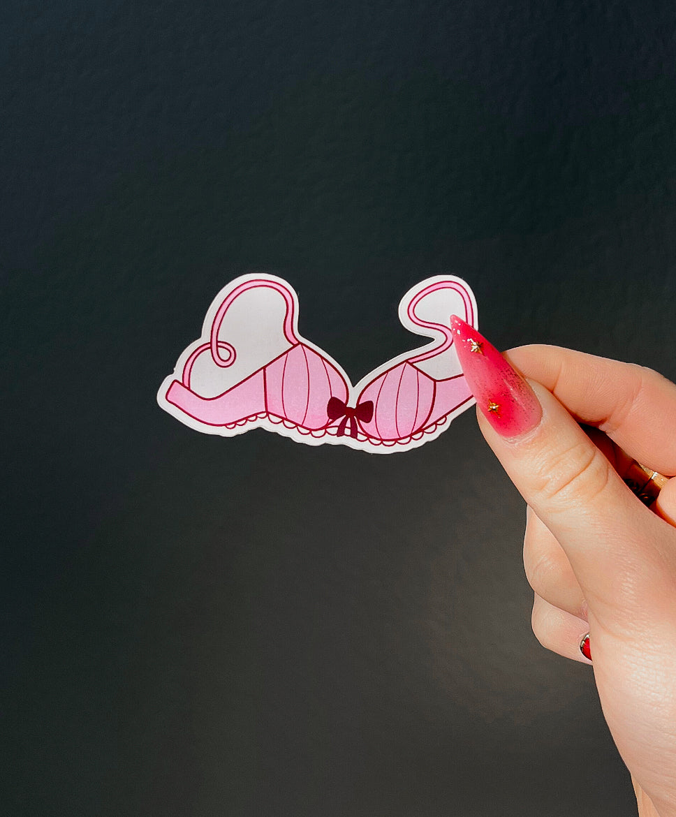 Bra sticker of the Lingerie Sticker Set next to a hand for size comparison