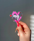 Love Gun Sticker with a transparent background next to a hand for size comparison