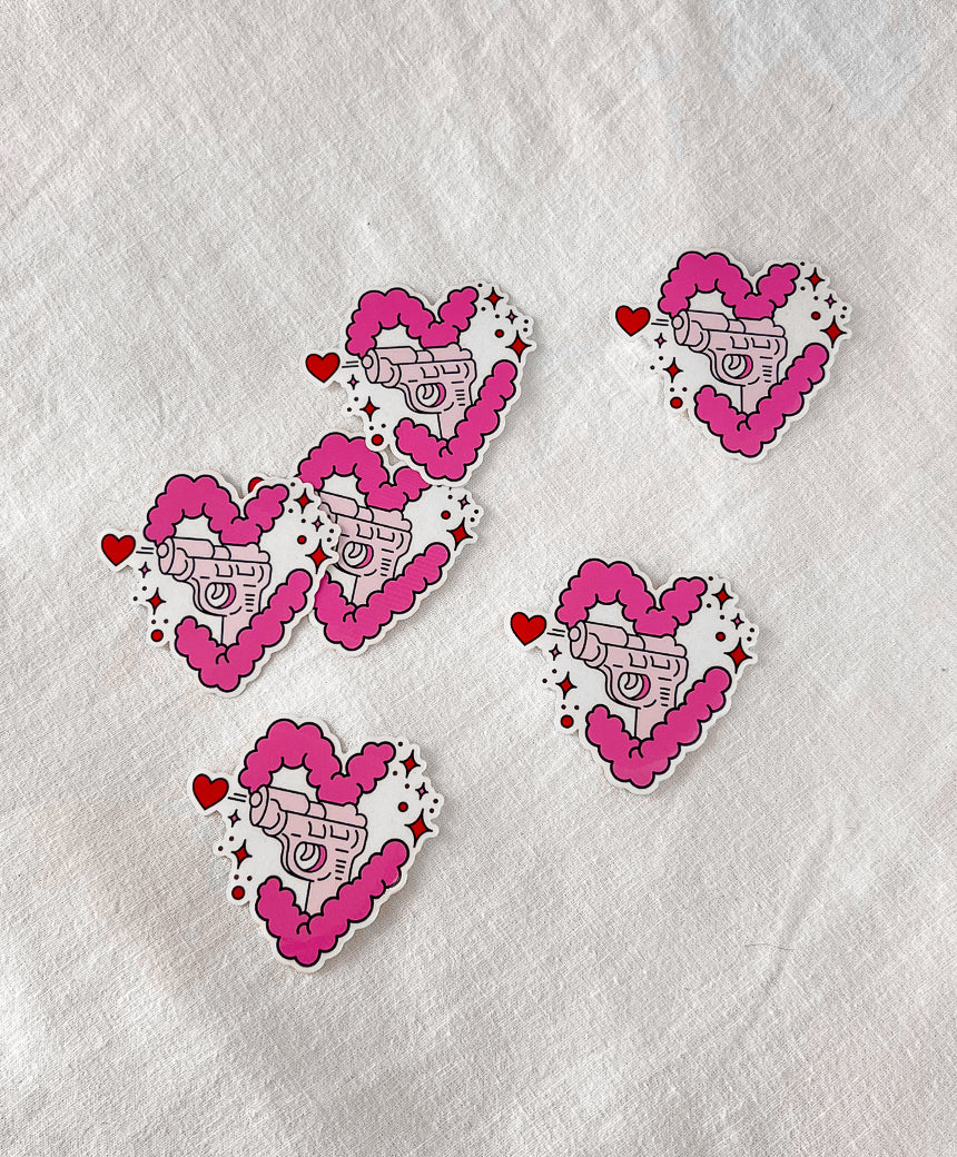 Love Gun Stickers laying on a flay surface
