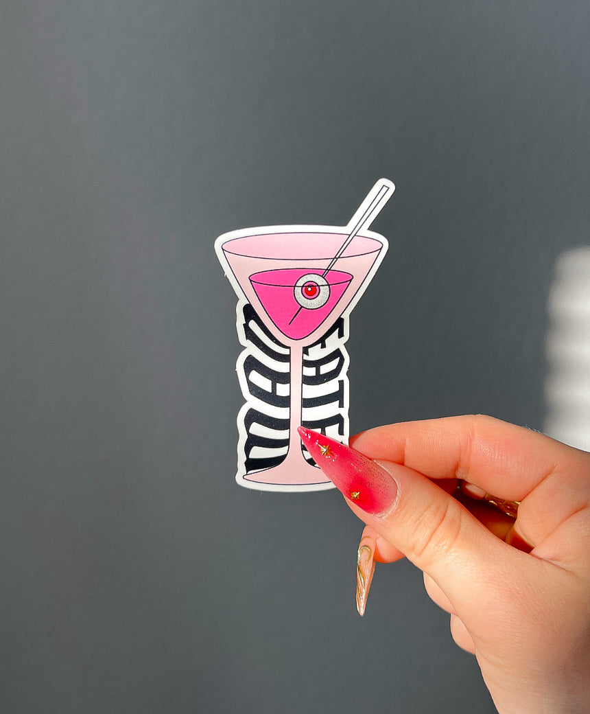 Man Eater Martini Sticker next to a hand for size comparison