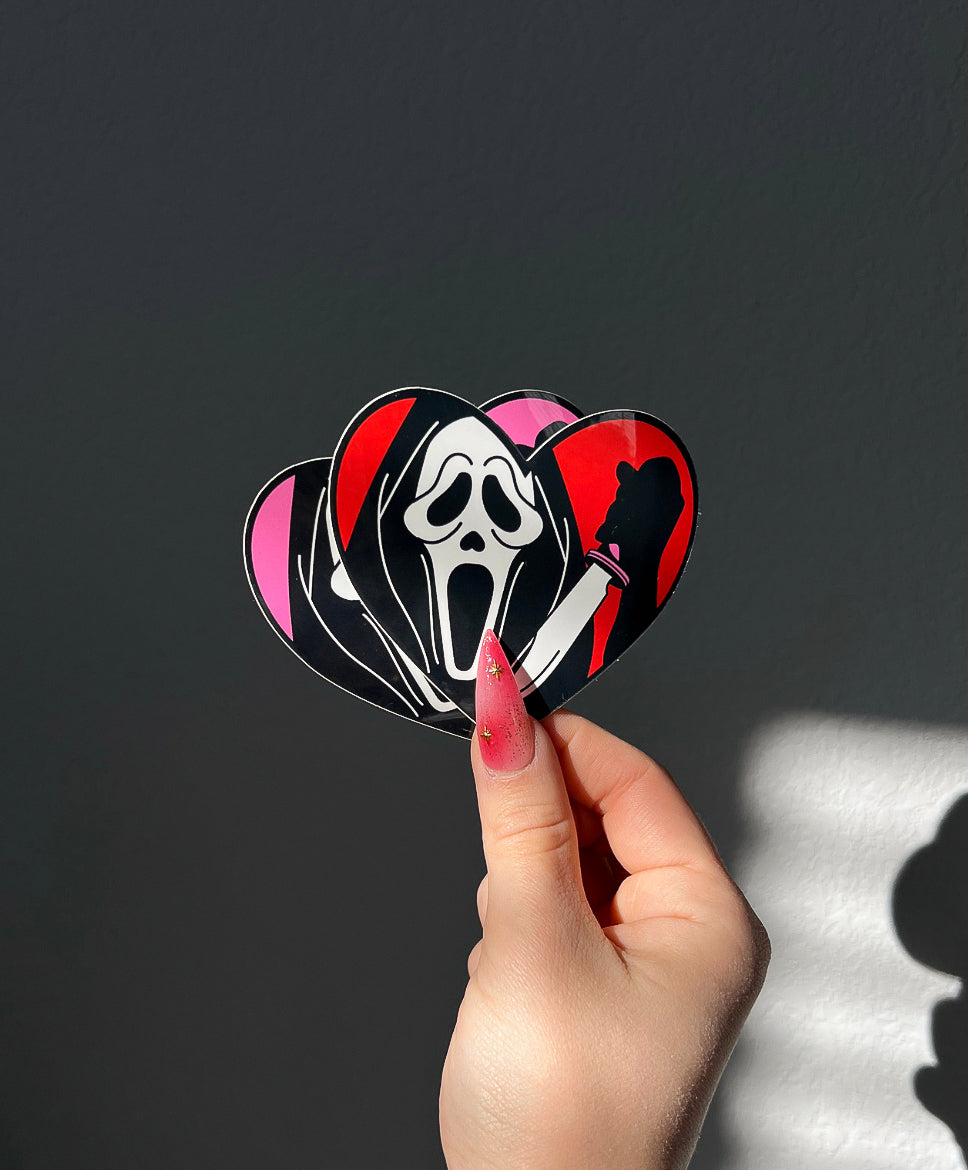 Masked Heart Vinyl Sticker in Red and Pink next to a hand for size comparison