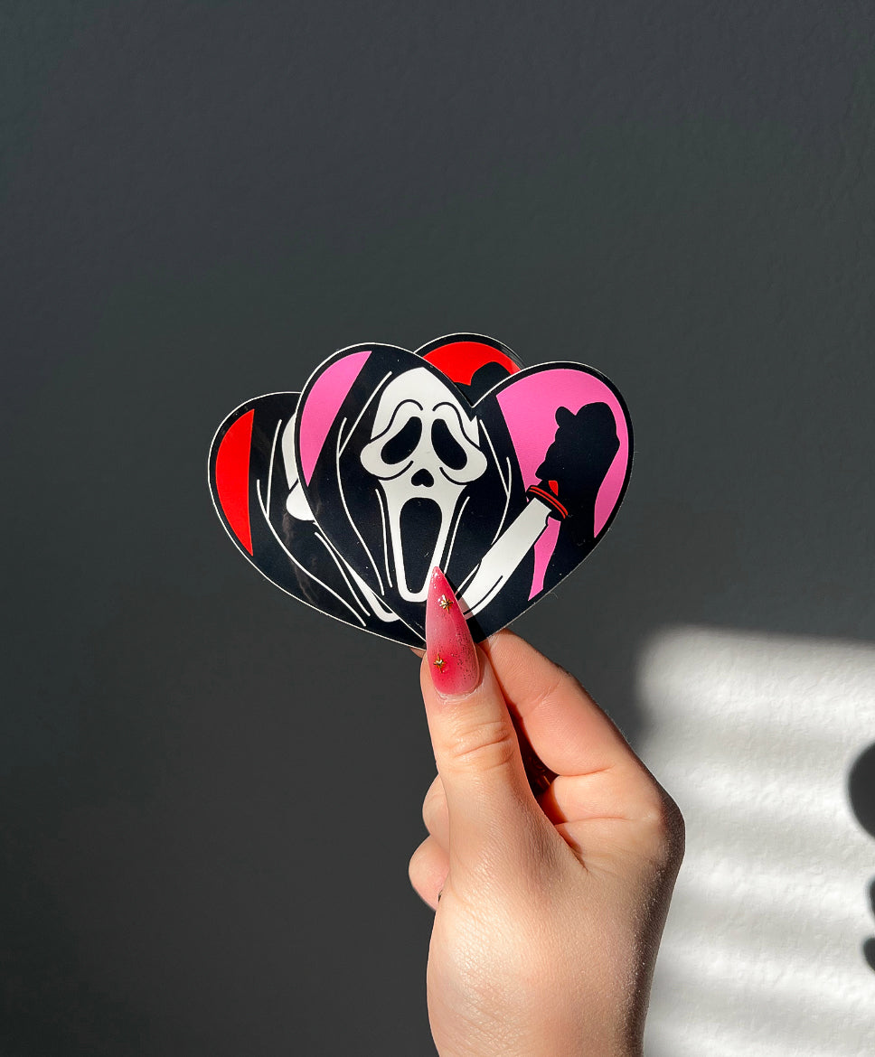 Masked Heart Vinyl Sticker in Red and Pink next to a hand for size comparison
