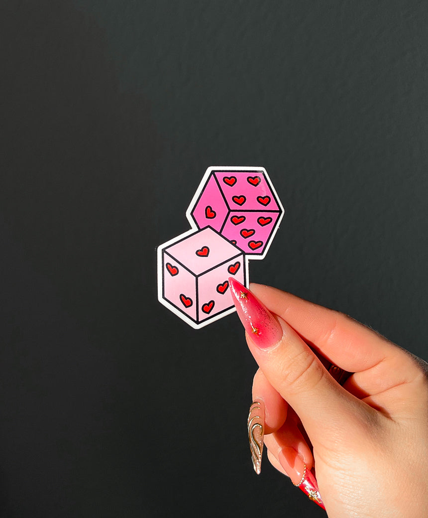 Roll the Dice Sticker in sunlight next to a hand for size comparison