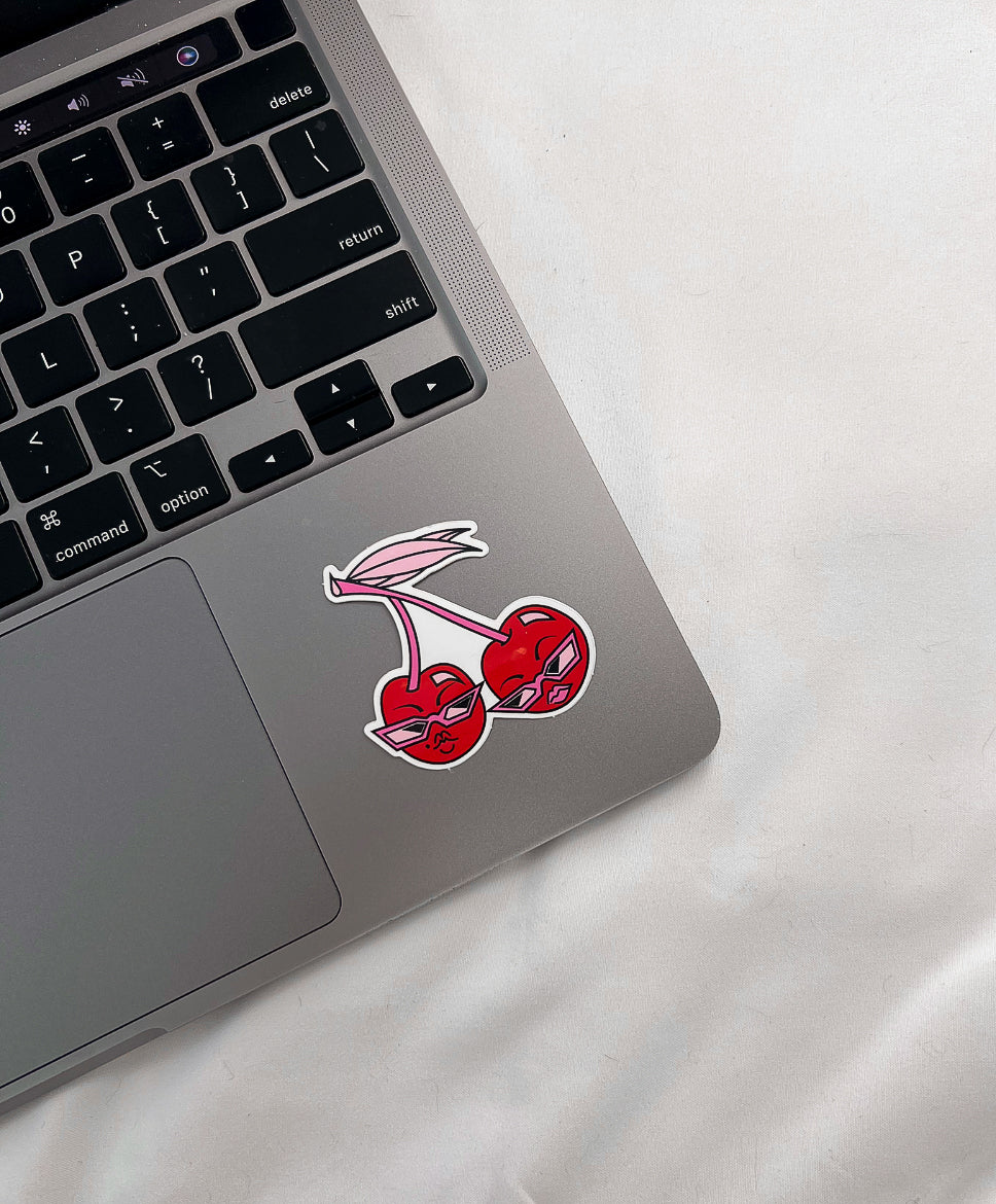 Sunny Cherry Sticker on laptop computer for size comparison