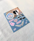 Divine Feminine sticker sheet featuring Mac Miller, Creation of Adam, angel wings, teddy bear, and pastel cloud background.