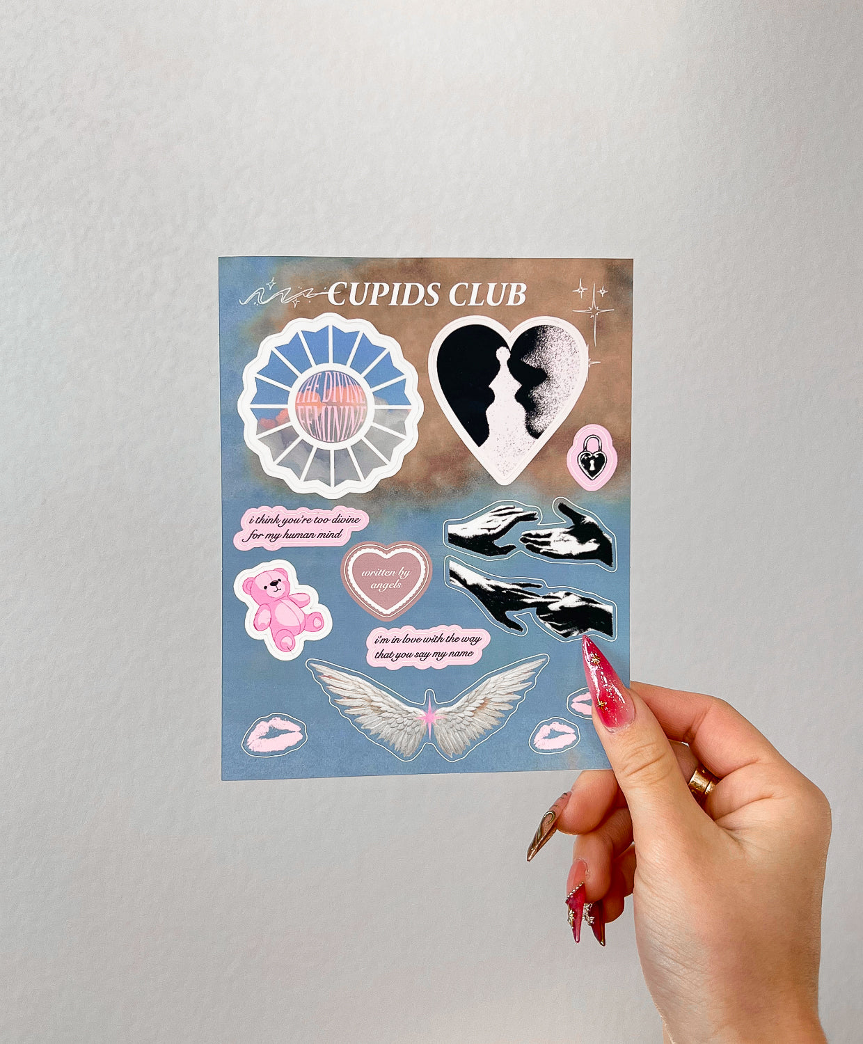 Divine Feminine stickers next to a hand for size comparison